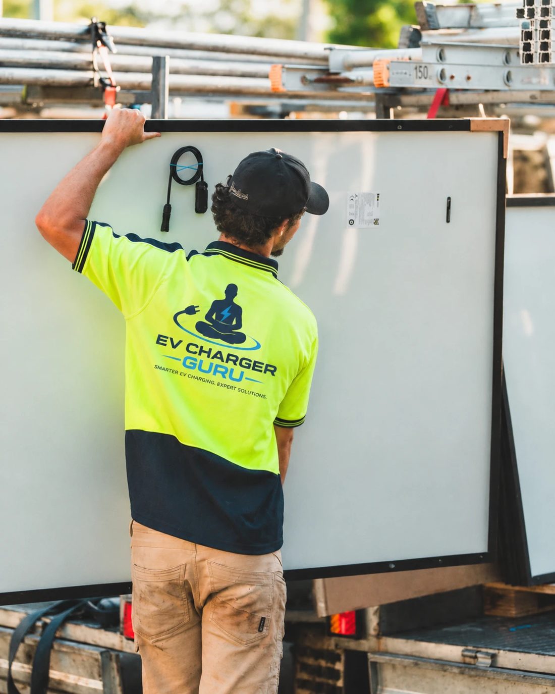 EV Charger Guru partner electrician in a branded hi-vis polo